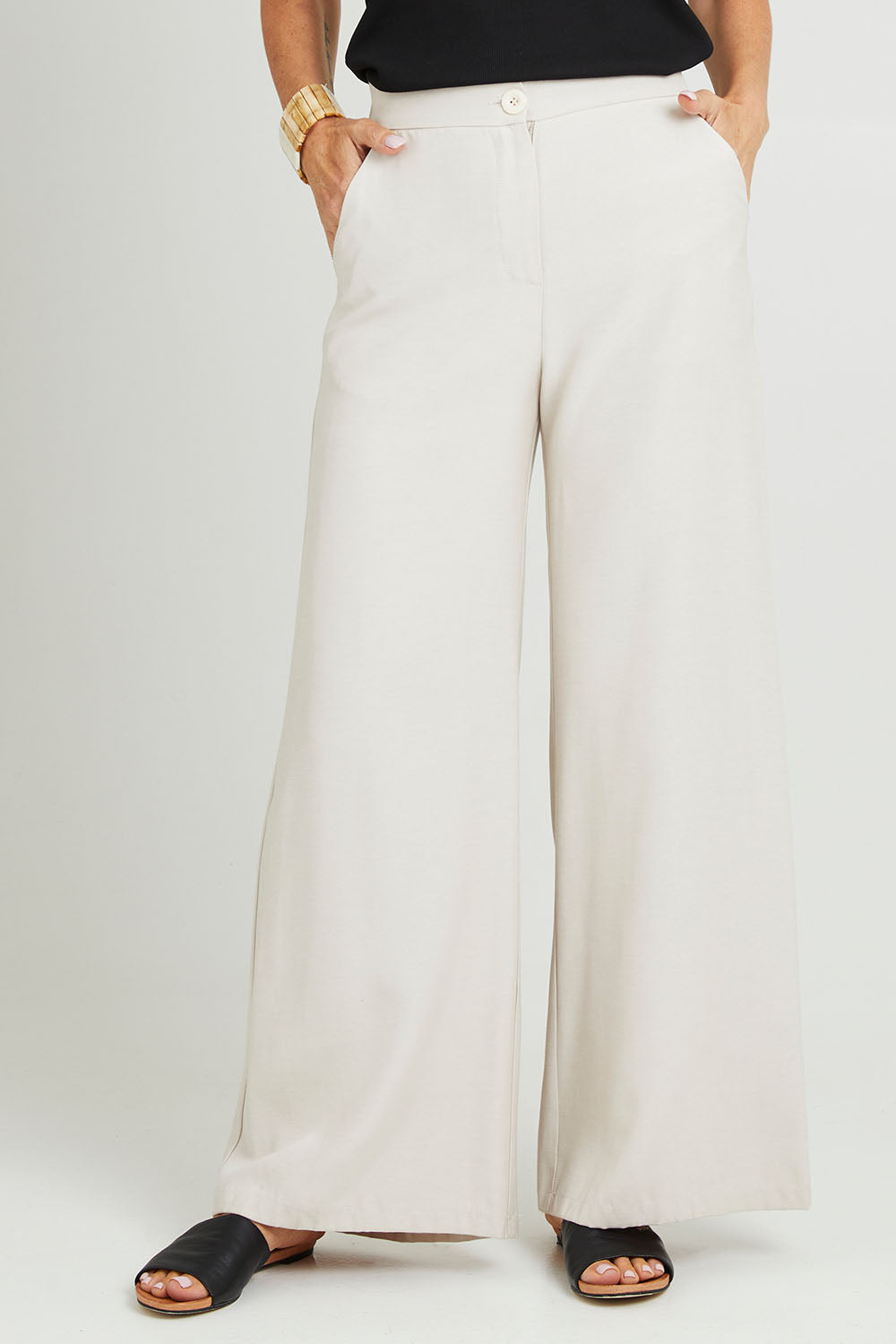 Model Luisa wearing size 10 of the Striding Out Wide Leg Pants in colour Moet, from the front, cropped image