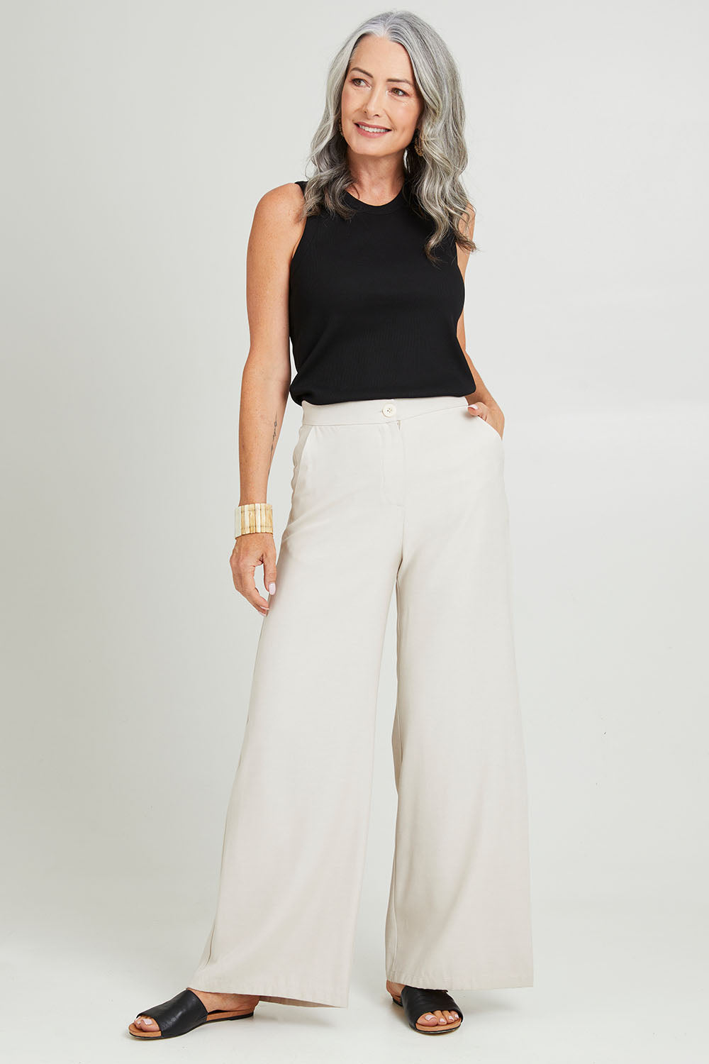 Model Luisa wearing size 10 of the Striding Out Wide Leg Pants in colour Moet, from the front, showing the whole outfit
