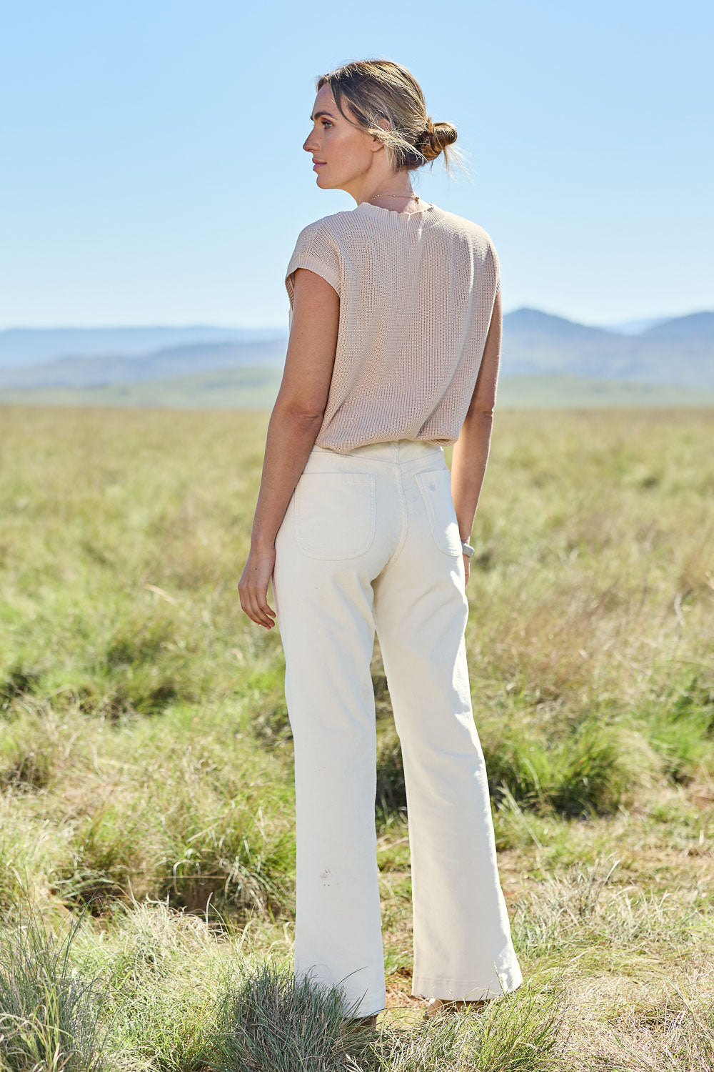 Model Tegan wearing size 10 of the Forever Cool Cord Jeans in colour Milk (White), from the front, showing the whole outfit