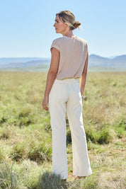 Model Tegan wearing size 10 of the Forever Cool Cord Jeans in colour Milk (White), from the front, showing the whole outfit