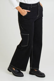 Model Laura wearing size 14 of the Carry Me With You Cargo Jeans in colour Black (Black), from the front, cropped image
