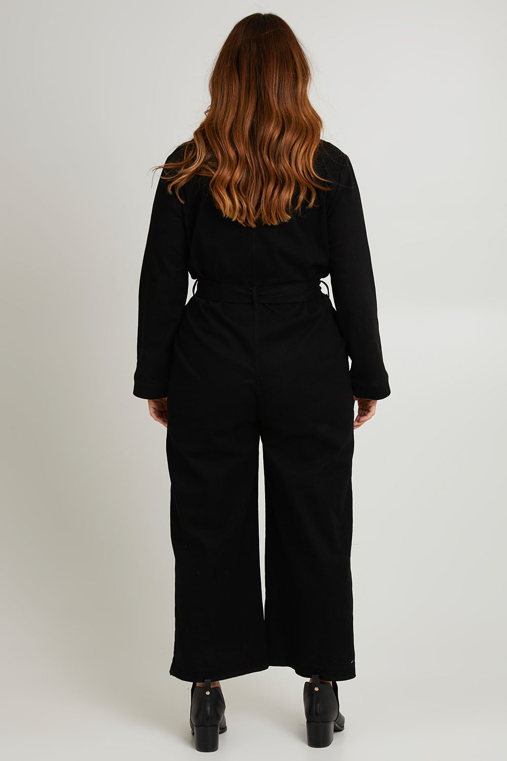 Model Laura wearing size 14 of The Places You Go Jumpsuit in colour Black (Black), from the back