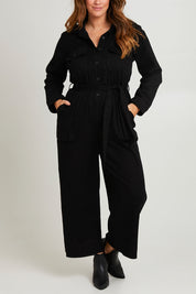 Model Laura wearing size 14 of The Places You Go Jumpsuit in colour Black (Black), from the front, cropped image