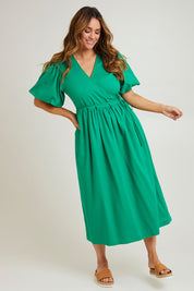 Model Laura wearing size 14 of the Lunch With The Girls Wrap Dress in colour Emerald (Green), from the front, showing the whole outfit
