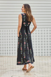 Model Tegand wearing size 10 of the Fleur Muse Embroidered Dress – Black in colour Black, from the front