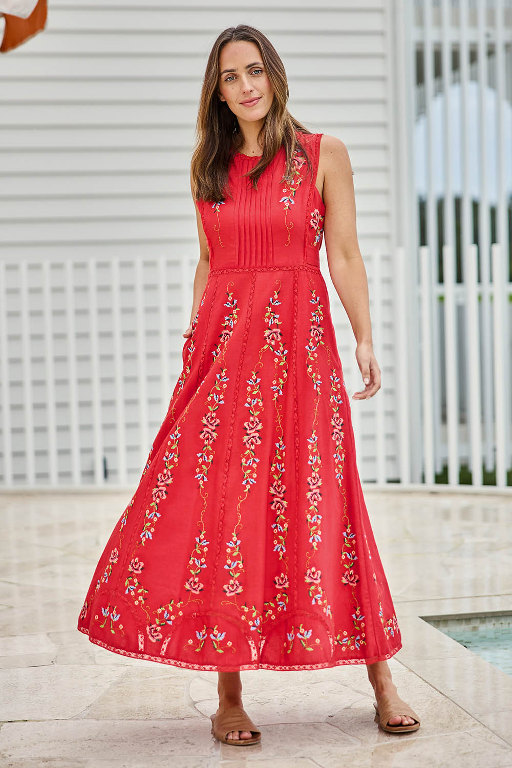 Model Tegand wearing size 10 of the Fleur Muse Embroidered Dress – Red in colour Red, from the front