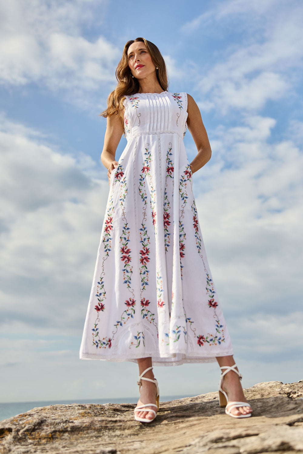 Model Clementine wearing size 10 of the Fleur Muse Embroidered Dress in colour White (White), from the front, showing the whole outfit