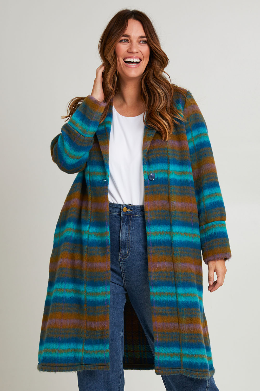 Model Laura wearing size 14 of the Check Me Out Coat in colour Tealcheck (Blue), from the front, cropped image
