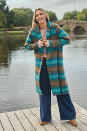 Model Tegan wearing size 10 of the Check Me Out Coat in colour Tealcheck (Blue), from the front, showing the whole outfit