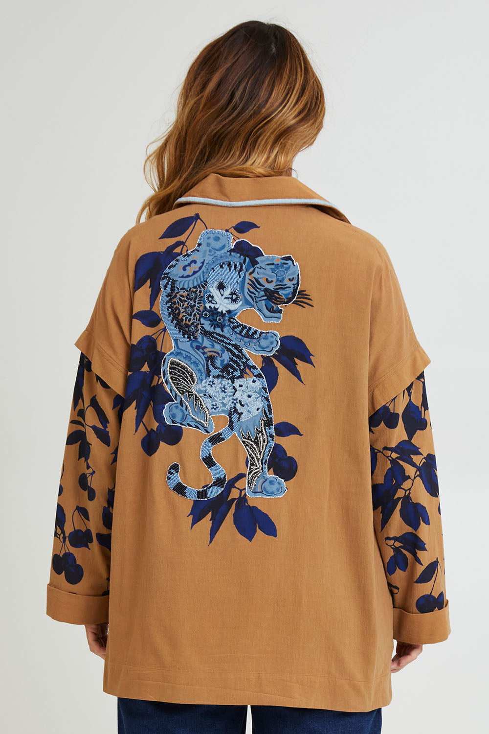 Model Laura wearing size 14 of the Tigers Eye Cotton Jacket in colour Rust, from the back