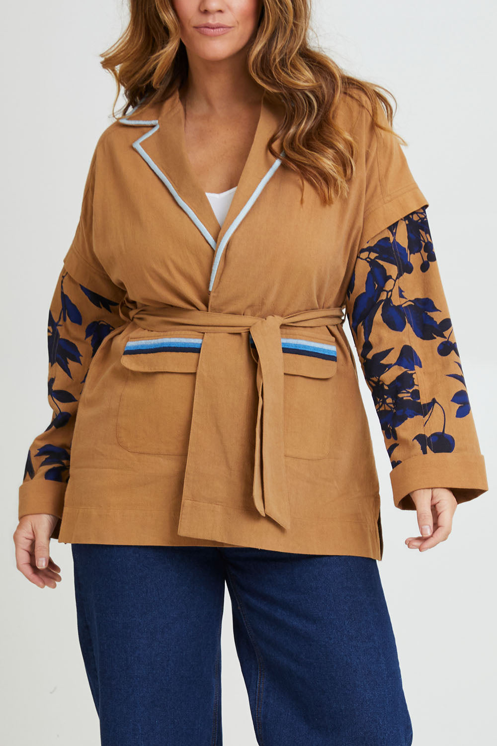 Model Laura wearing size 14 of the Tigers Eye Cotton Jacket in colour Rust, from the front, cropped image