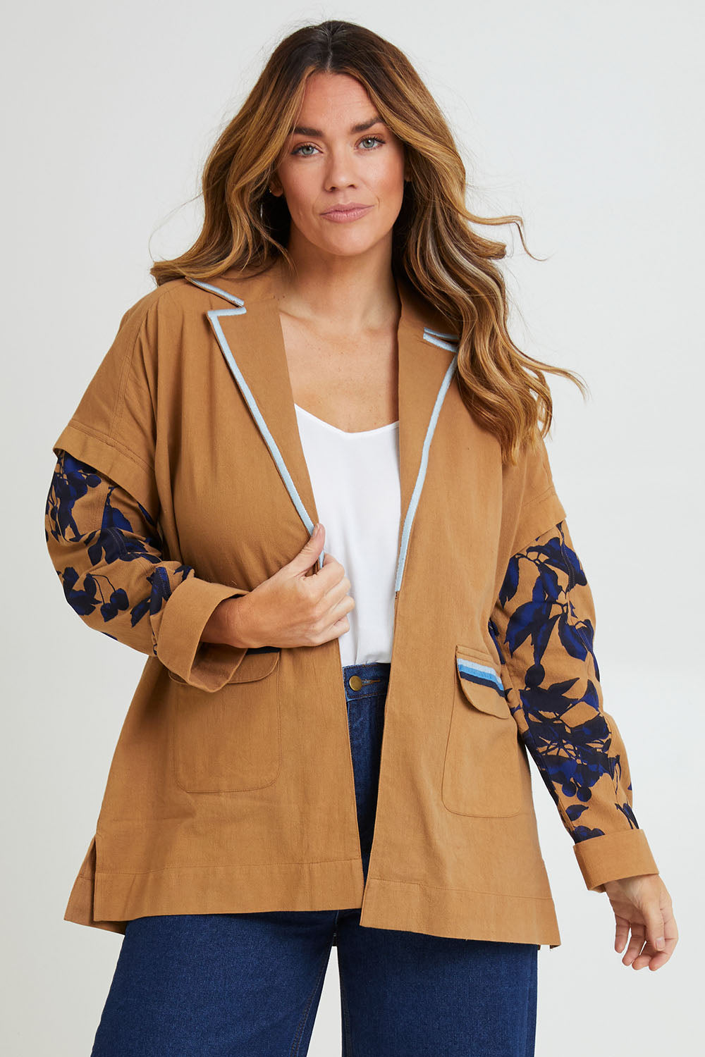 Model Laura wearing size 14 of the Tigers Eye Cotton Jacket in colour Rust, from the front, cropped image