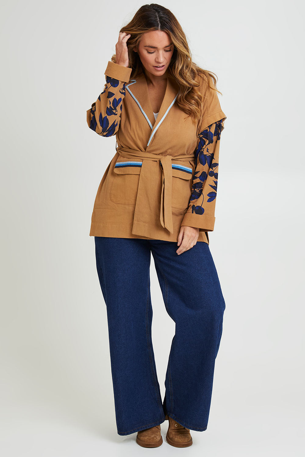 Model Laura wearing size 14 of the Tigers Eye Cotton Jacket in colour Rust, from the front, showing the whole outfit