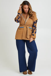 Model Laura wearing size 14 of the Tigers Eye Cotton Jacket in colour Rust, from the front, showing the whole outfit