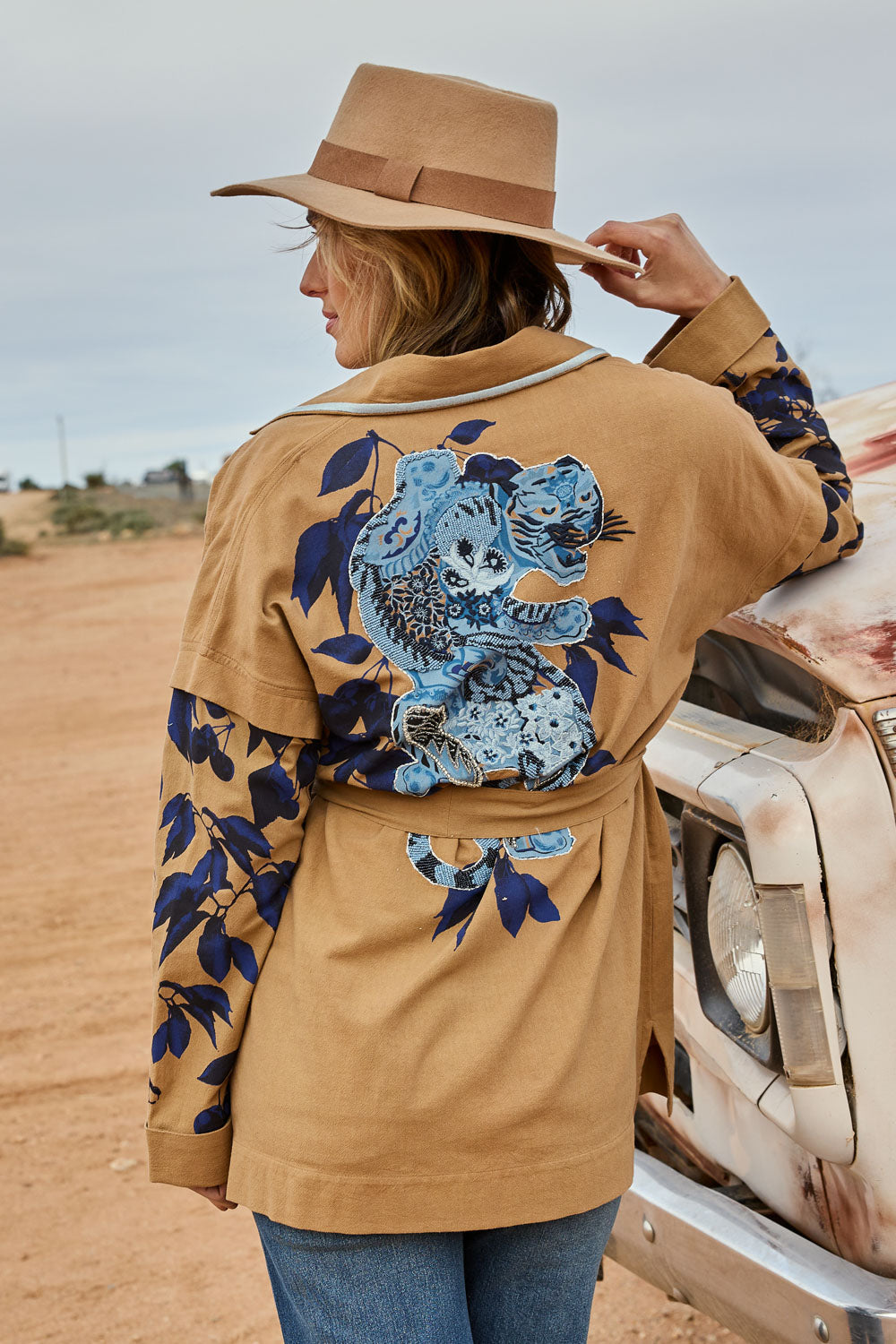 Model Tegan wearing size 10 of the Tigers Eye Cotton Jacket in colour Rust, from the front, showing the whole outfit