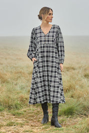 Model Tegan wearing size 10 of the Ready For A Picnic Smock Dress in colour Blkcheck (Black), from the front, showing the whole outfit