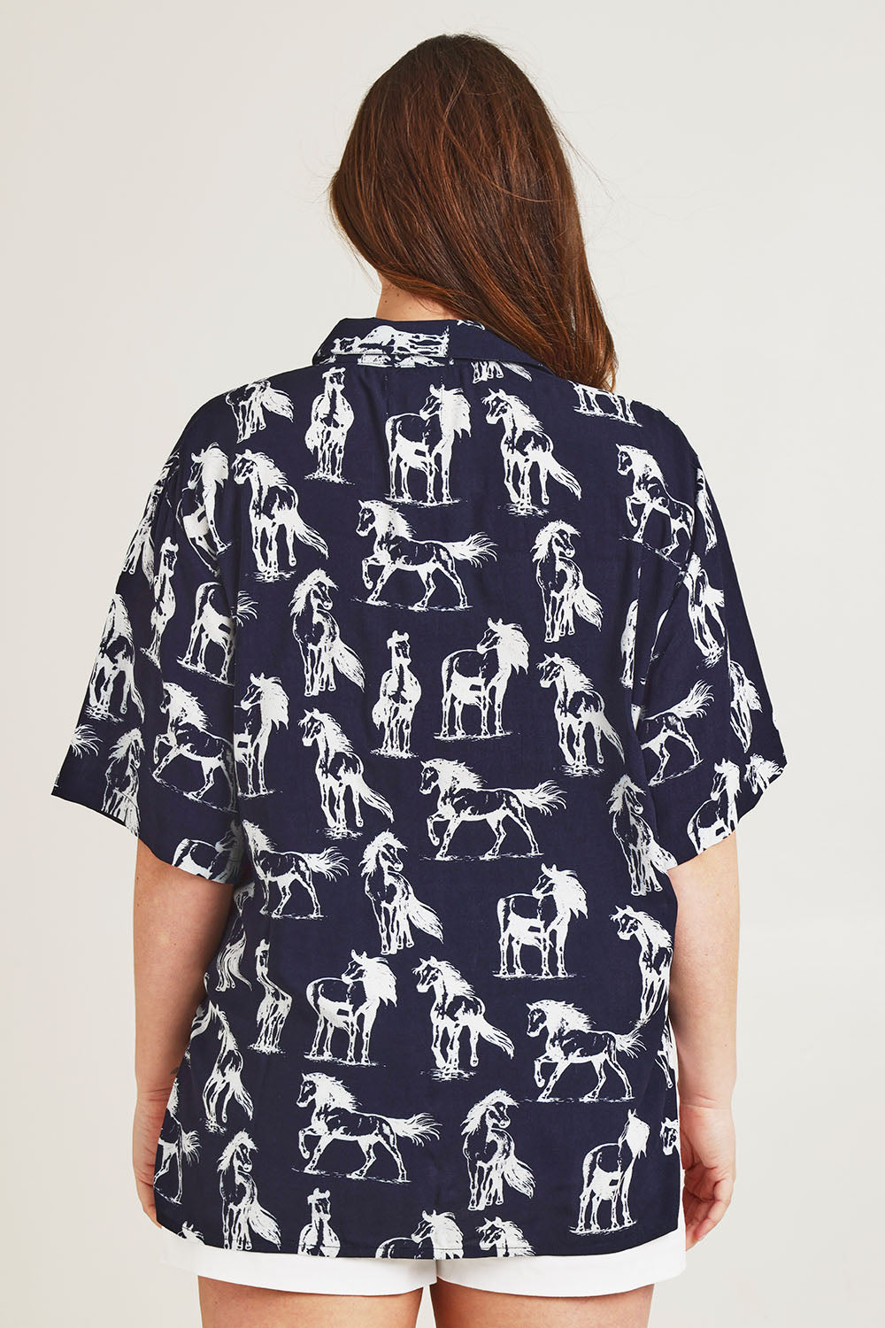 Model Jane wearing size 14 of the Wild Horses Oversized Shirt in colour Navyhorse (Blue), from the back