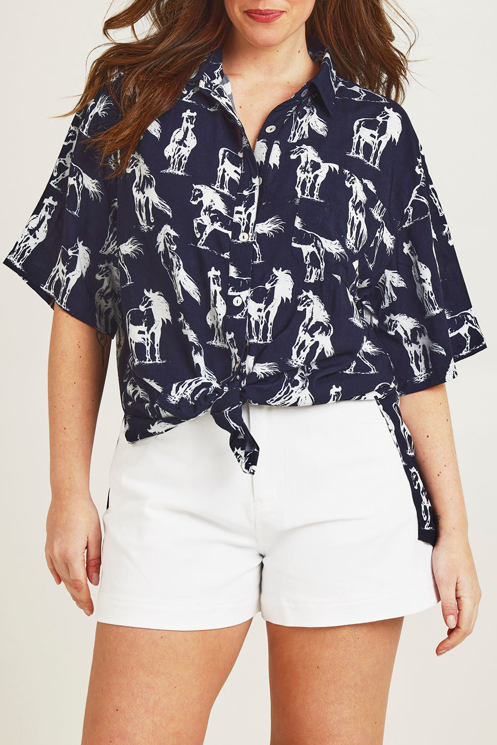 Model Jane wearing size 14 of the Wild Horses Oversized Shirt in colour Navyhorse (Blue), from the front, cropped image