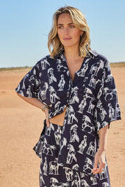 Model Tegan wearing size 10 of the Wild Horses Oversized Shirt in colour Navyhorse (Blue), from the front, showing the whole outfit