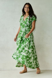 Model Tahnee wearing size 10 of the Double Take Wrap Dress in colour Grnfleur (Green), from the front, showing the whole outfit