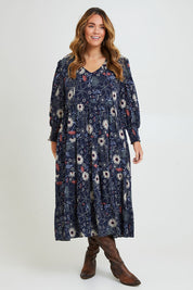 Model Laura wearing size 14 of the Falling Flowers Maxi Dress in colour Navyfleur (Blue), from the front, showing the whole outfit