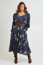 Model Laura wearing size 14 of the Falling Flowers Maxi Dress in colour Navyfleur (Blue), from the front, showing the whole outfit