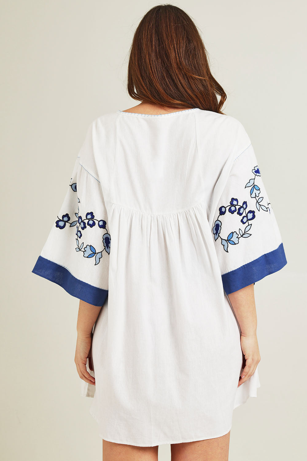 Model Jane wearing size 14 of the Picking Posies Embroidered Dress in colour White (White), from the back