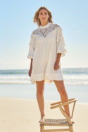 Model Tegan wearing size 10 of the Romance Me Dress in colour Milk (White), from the front, showing the whole outfit