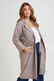 Model Laura wearing size 14 of the Living Life Slouch Jacket in colour Bark, from the front, cropped image