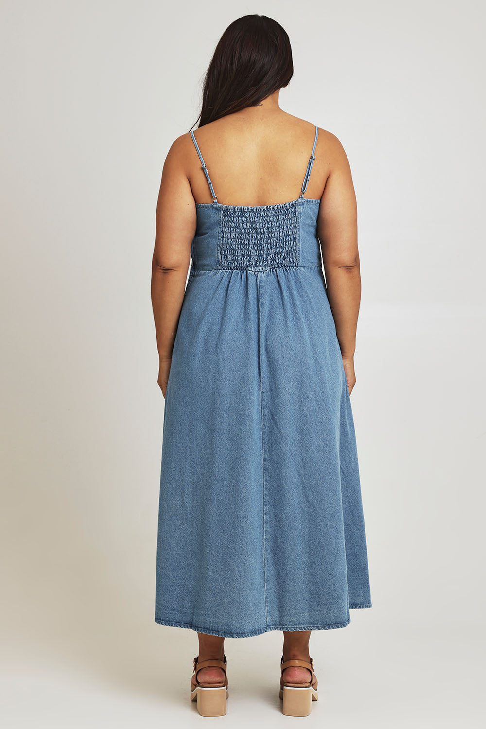 Model Ashleigh wearing size 16 of the For All Seasons Denim Dress in colour Denim (Blue), from the back