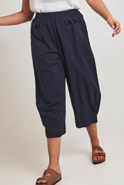 Model Terri-Leigh wearing size 14 of the You Had Me At First Glance Pants in colour Indigo (Blue), from the front, cropped image