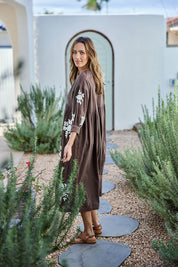 Model Tegand wearing size 10 of the Day Dreaming Embroidered Dress – Dustychoc in colour Dustychoc, from the front