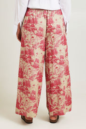 Model Jane wearing size 14 of the Toile De Jouy Pants in colour Pinktoile (Pink), from the back