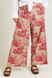 Model Jane wearing size 14 of the Toile De Jouy Pants in colour Pinktoile (Pink), from the front, cropped image