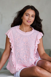 Model Tahnee wearing size 10 of the Easy Frills Embroidered Top in colour Blossom (Pink), from the front, showing the whole outfit