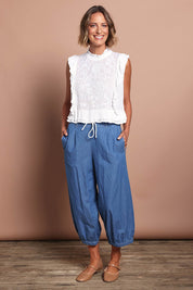 Model Riina wearing size 10 of the Easy Frills Embroidered Top in colour Milk (White), from the front, showing the whole outfit