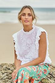 Model Tegan wearing size 10 of the Easy Frills Embroidered Top in colour Milk (White), from the front, showing the whole outfit