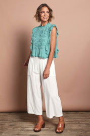 Model Riina wearing size 10 of the Easy Frills Embroidered Top in colour Pistachio (Green), from the front, showing the whole outfit