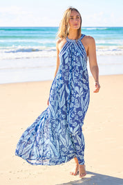 Model Tegan wearing size 10 of the Garden Party Halter Neck Dress in colour Bluefleur (Blue), from the front, showing the whole outfit