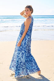 Model Tegan wearing size 10 of the Garden Party Halter Neck Dress in colour Bluefleur (Blue), from the front, showing the whole outfit