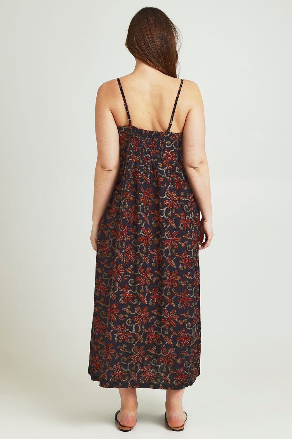 Model Jane wearing size 14 of the At Sunset Maxi Dress in colour Midnight (Black), from the back