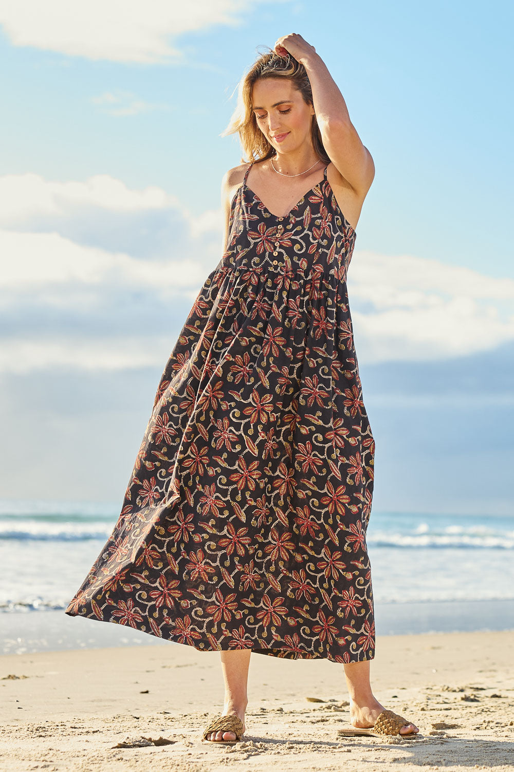 Model Tegan wearing size 10 of the At Sunset Maxi Dress in colour Midnight (Black), from the front, showing the whole outfit