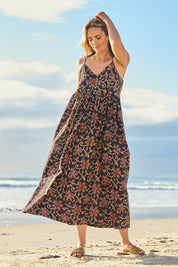 Model Tegan wearing size 10 of the At Sunset Maxi Dress in colour Midnight (Black), from the front, showing the whole outfit