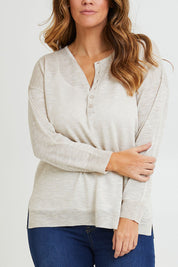 Model Laura wearing size L of the Go To Knit Boyfriend Henley in colour Natural, from the front, cropped image
