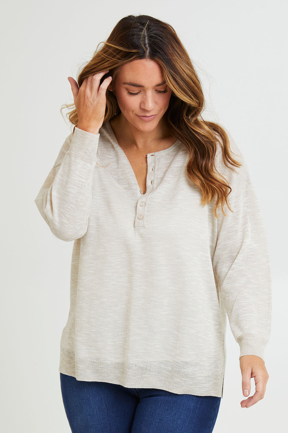 Model Laura wearing size L of the Go To Knit Boyfriend Henley in colour Natural, from the front, cropped image