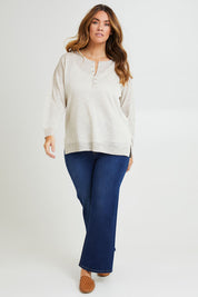 Model Laura wearing size L of the Go To Knit Boyfriend Henley in colour Natural, from the front, showing the whole outfit