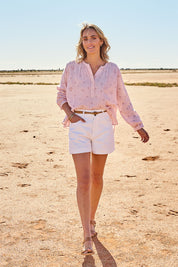 Model Tegan wearing size 10 of the Too Good High Rise Denim Short in colour White (White), from the front, showing the whole outfit