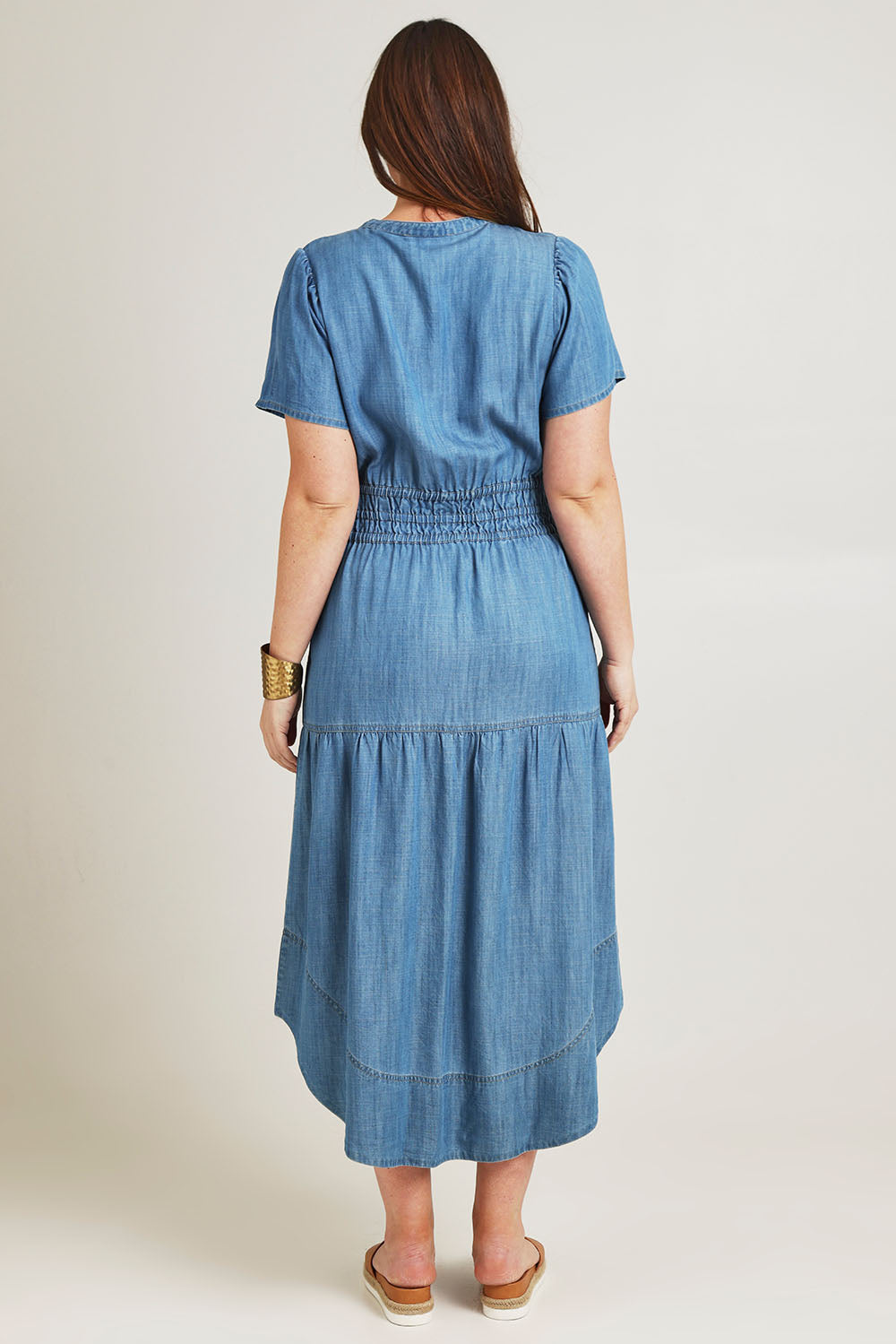 Model Jane wearing size 14 of the Beautiful Moments Dress in colour Chambray (Blue), from the back