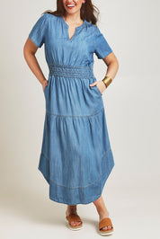 Model Jane wearing size 14 of the Beautiful Moments Dress in colour Chambray (Blue), from the front, cropped image