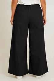 Model Laura wearing size 14 of the Need You In My Life Pants in colour Black (Black), from the back